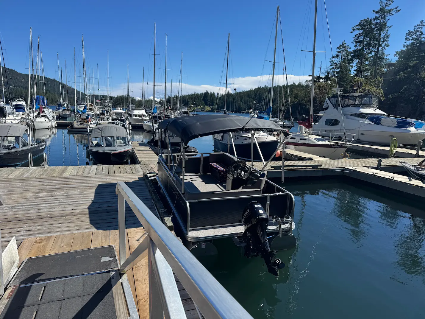 Coastal Boat Tours pontoon boat docked at Pender Harbour Resort & Marina